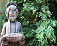 a garden statue made of natural stone